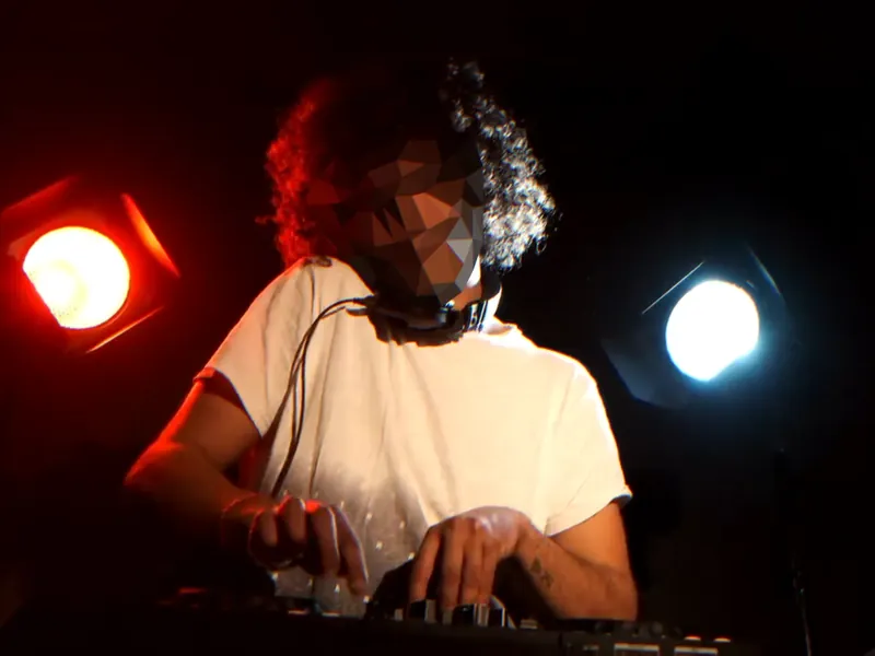 A live camera: the LOW-POLY mask on a DJ at the decks